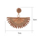 Side view of raffia fan shaped drop earrings showing woven texture