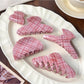 Beau pink plaid crescent shaped claw clip on white background