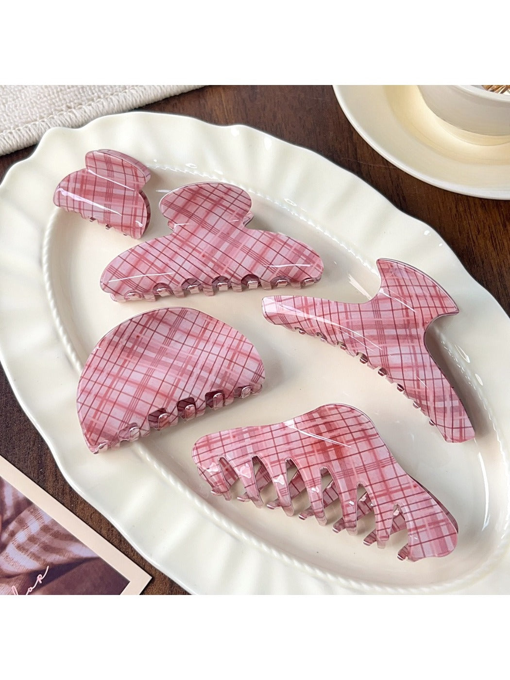 Beau pink plaid crescent shaped claw clip on white background