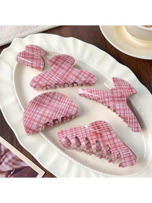 Beau pink plaid crescent shaped claw clip on white background