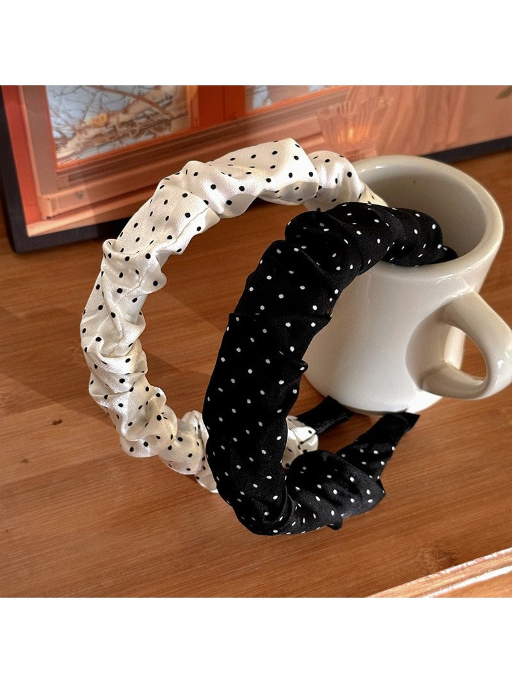 Close-up of Gifty pleated polka dot headband showing fabric texture and pleats