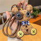 Vintage little bear keychain placed next to a notebook and pen on a desk