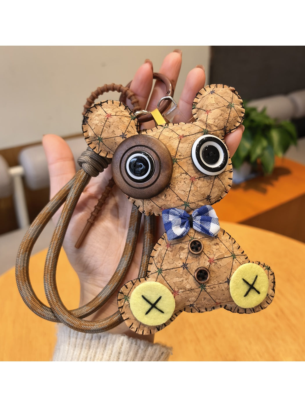 Vintage little bear keychain placed next to a notebook and pen on a desk
