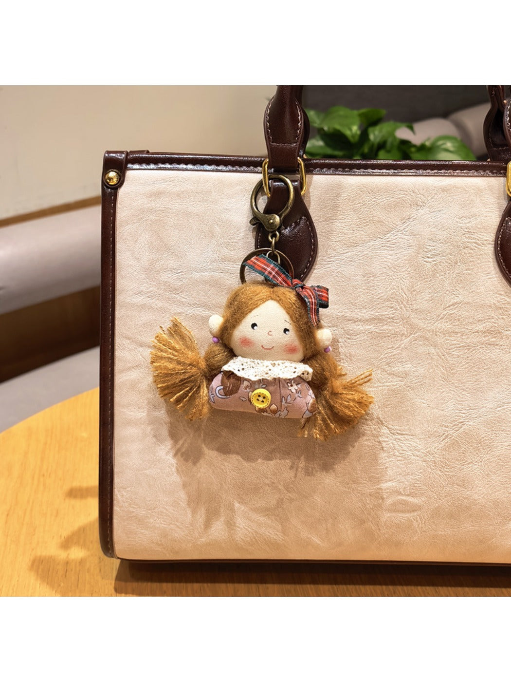 Vintage girl charm keychain next to a small gift box on a white background