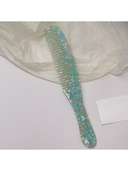 Camerow long handle hair comb displayed alongside hair care products