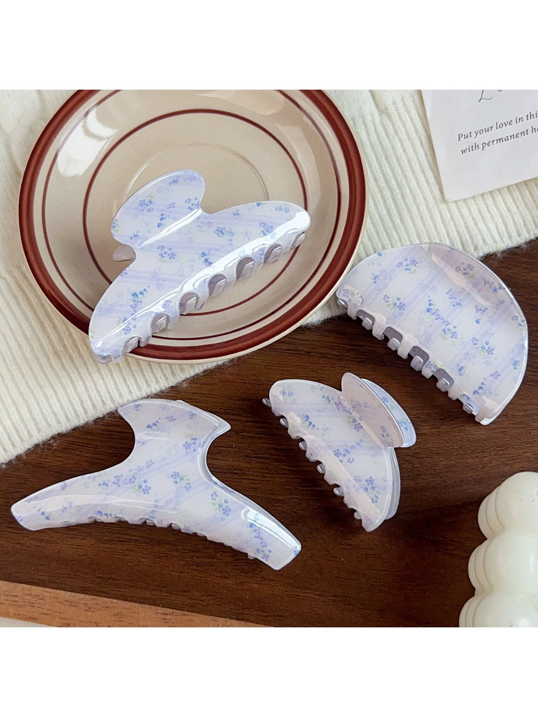 Close-up of Beau hair claw clip with blue floral pattern and curved teeth