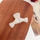 Beau minimalist bow shaped claw clip displayed with soft shadows