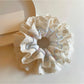 Close-up of blue lace fabric on double scrunchie showing texture and detail
