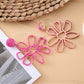 Pair of Earedge flower shaped openwork drop earrings displayed on white background