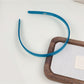 Close-up of smooth acetate material on Gifty solid color headband