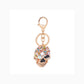 Gold-tone multicolor faceted skull keychain on white background
