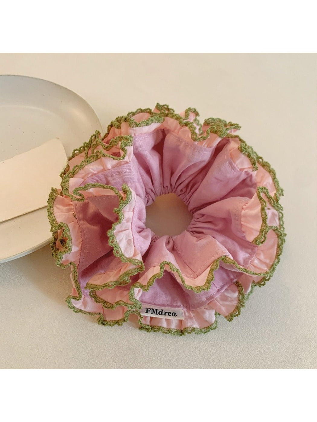 Close-up of pink lace trim detail on double scrunchie