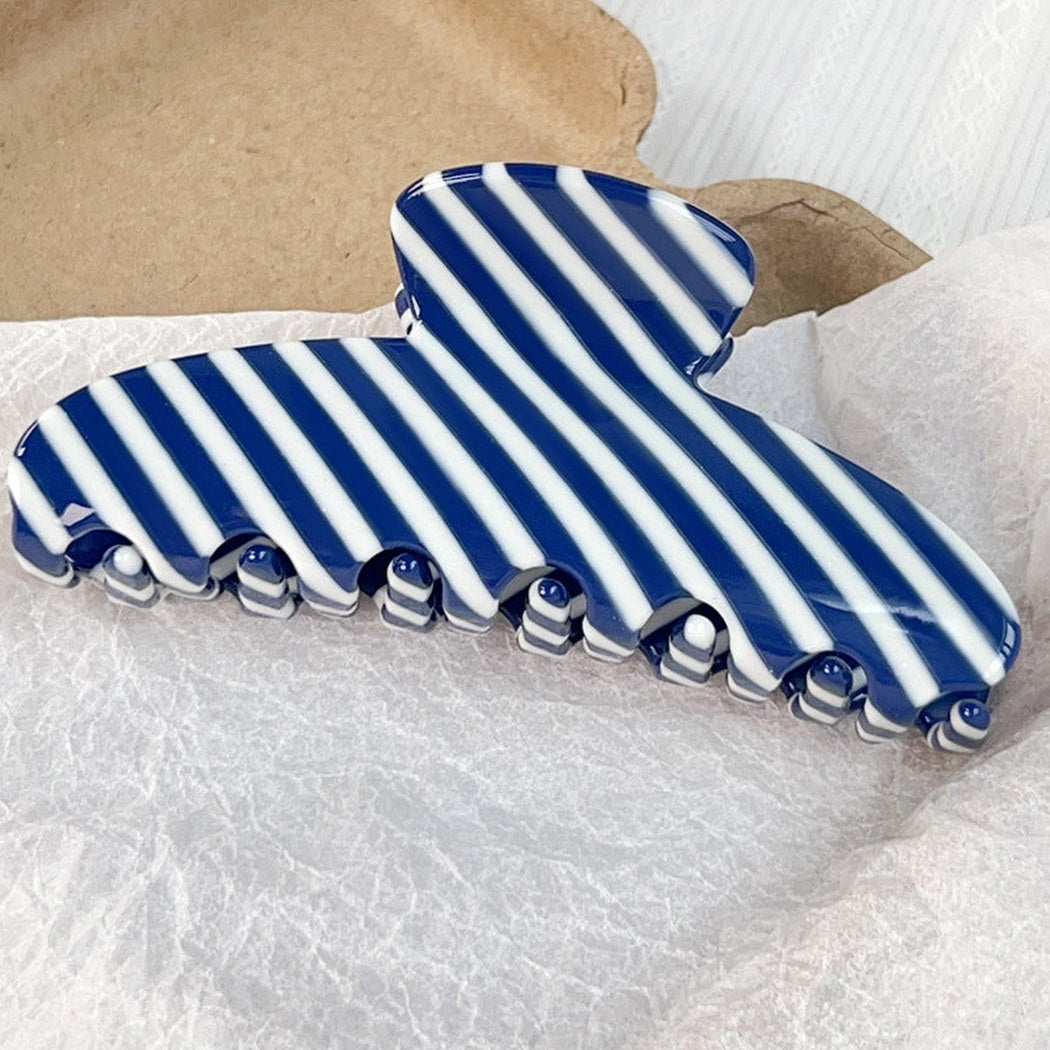 Blue and white striped hair claw clip, front view