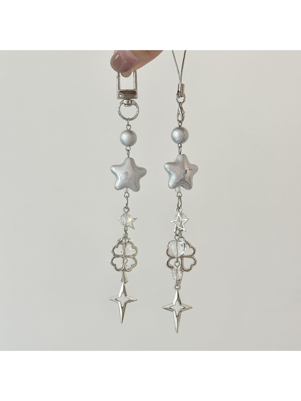 Star-shaped keychain reflecting rainbow colors held in hand