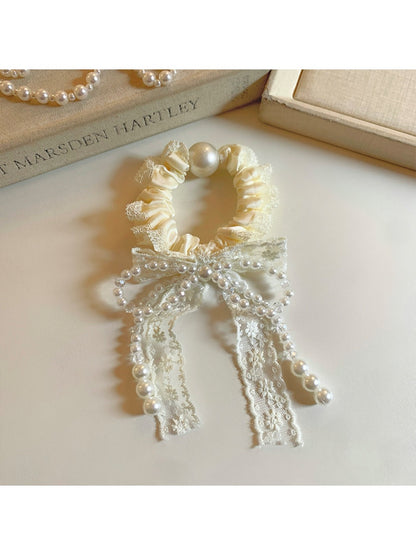 Gifty Sweet Beaded Bow Hair Tie laid flat highlighting bead arrangement and bow shape
