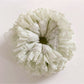 Close-up of Gifty sweet printed ruched scrunchie with pastel floral pattern