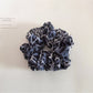 Detailed view of fabric pattern and texture on vintage leopard scrunchie