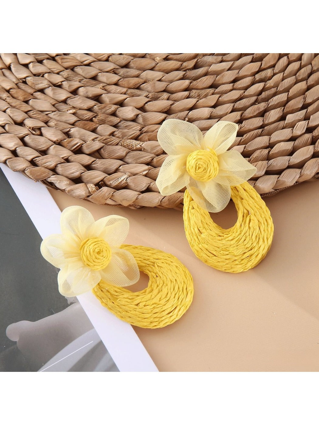 Sweet Raffia Flower Shaped Stud Earrings photographed with natural sunlight