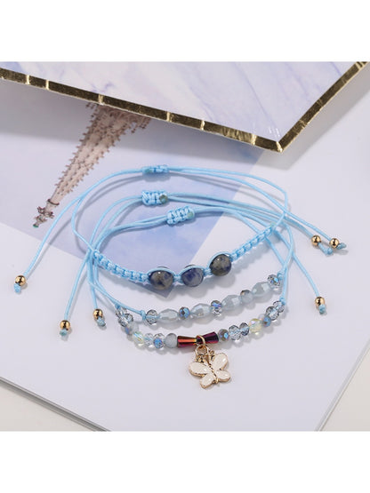 Side view of Lovra butterfly pendant on delicate small bead bracelet