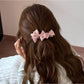 Beau satin bow banana clip worn in long brown hair from back