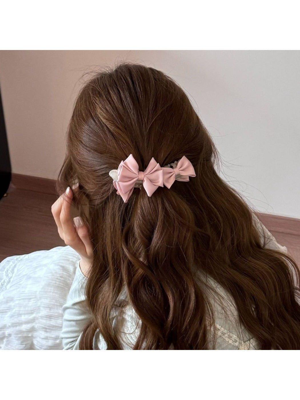 Beau satin bow banana clip worn in long brown hair from back
