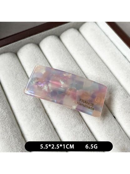 Beau curved bar hair clip shown with packaging box