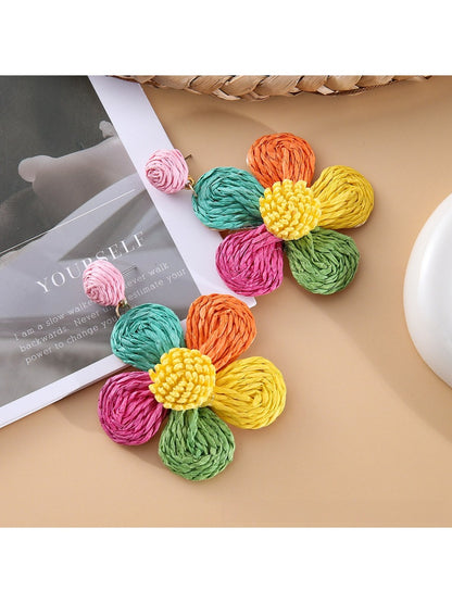 Earedge minimalist flower drop earrings displayed alongside matching accessories
