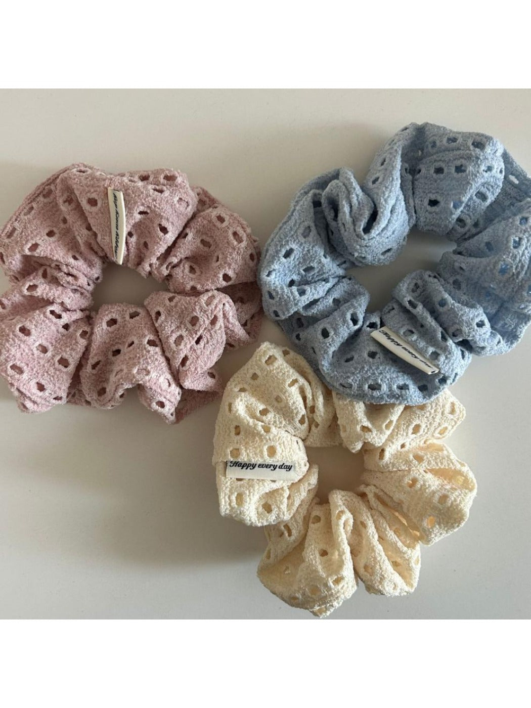 Scrunchie wrapped around a hand showing stretch and fabric detail