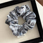 Gifty Dreamy Silky Retro Scrunchie held in hand highlighting silky fabric and retro design