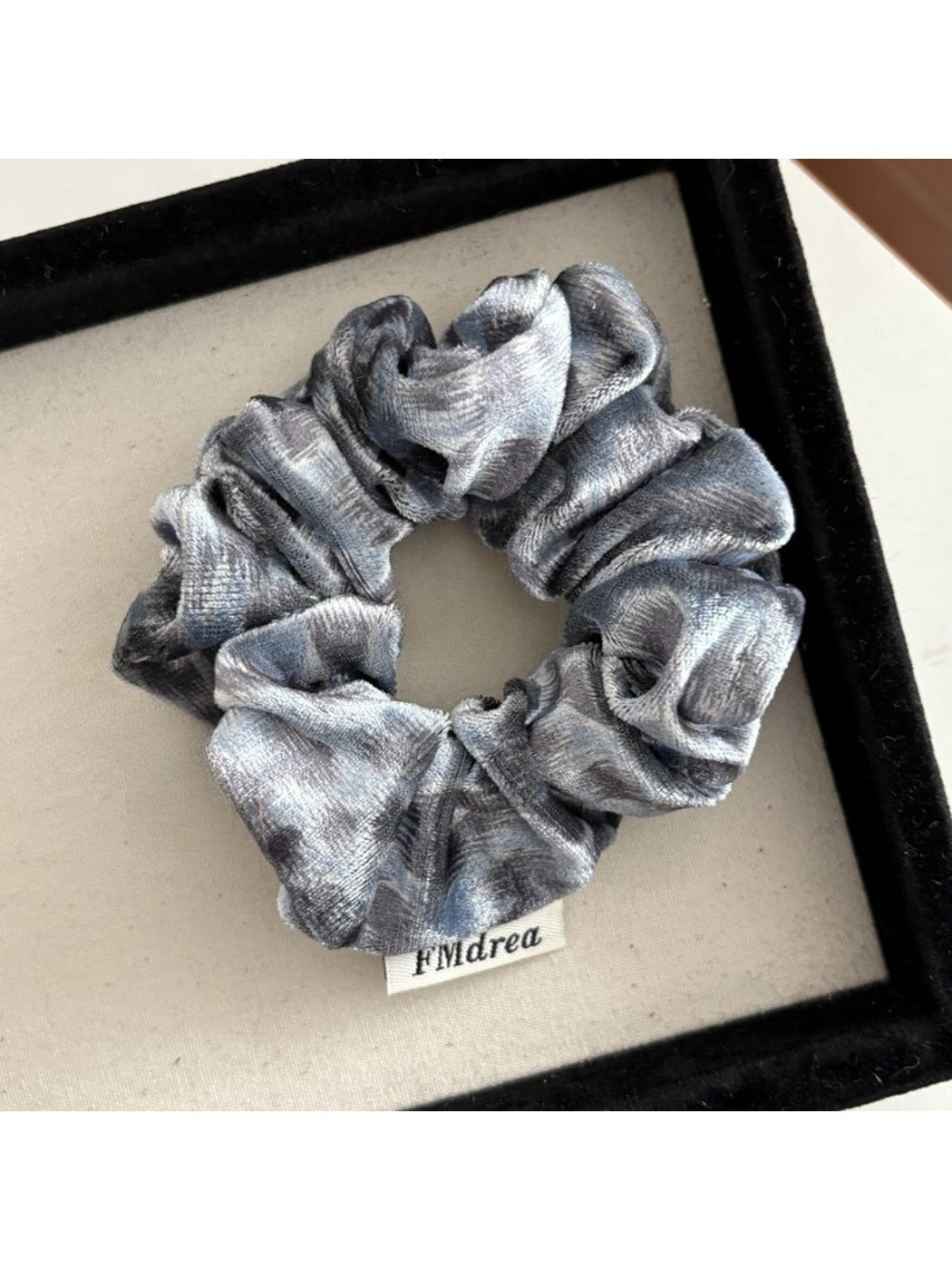 Gifty Dreamy Silky Retro Scrunchie held in hand highlighting silky fabric and retro design