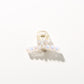 Bright multi color hair clip held near face to show scale