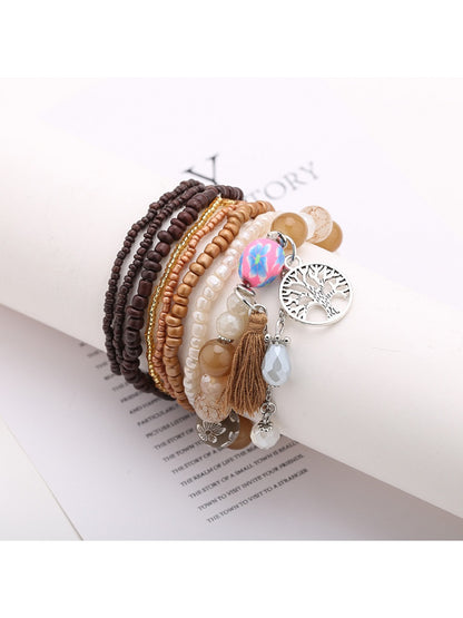Lovra tree shape tassel pendant beaded bracelet shown with natural lighting and shadows