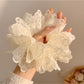 White double layer scrunchie styled on a model's wrist as an accessory
