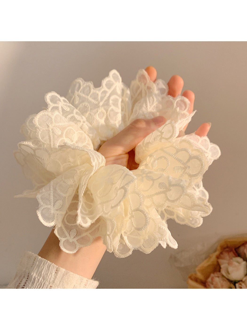 White double layer scrunchie styled on a model's wrist as an accessory