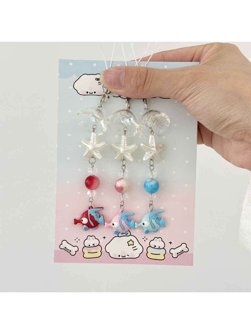 Mini fish shaped keychain in blue with a silver keyring attached