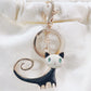 Black and white abstract cat keychain on fabric