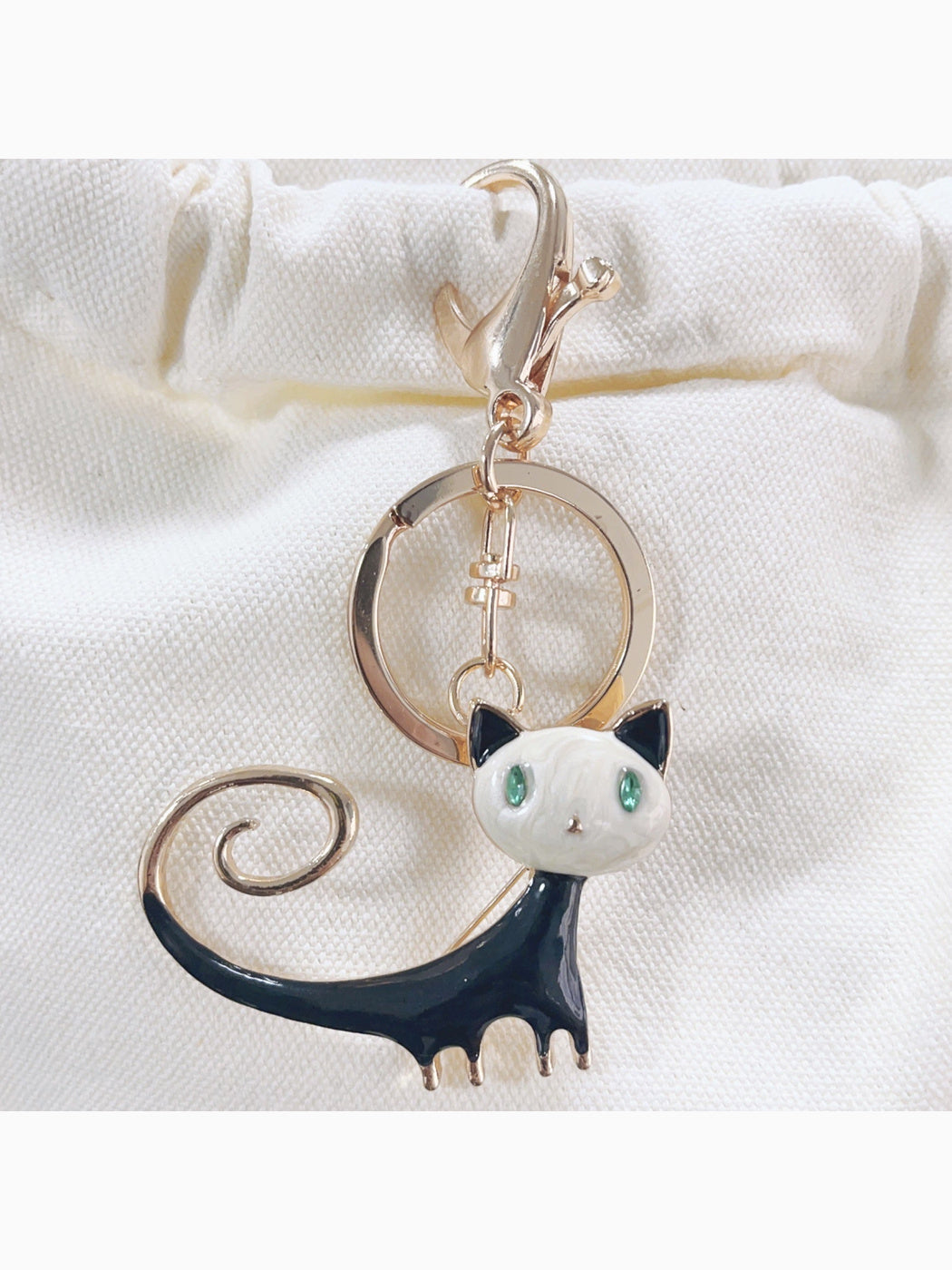 Black and white abstract cat keychain on fabric