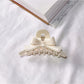 Beau acetate bow shaped claw clip with focus on bow knot detail