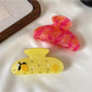 Beau cute fruit half round hair claw clip in yellow with green leaf detail on white background