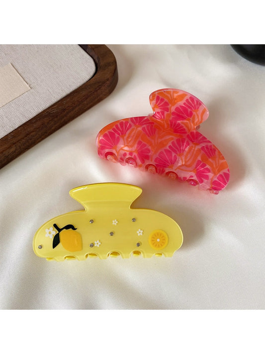 Beau cute fruit half round hair claw clip in yellow with green leaf detail on white background