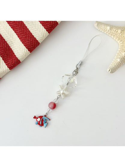 Mini fish keychain in green with a silver keyring on a wooden surface