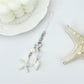 Mini starfish keychain held in a hand to show scale