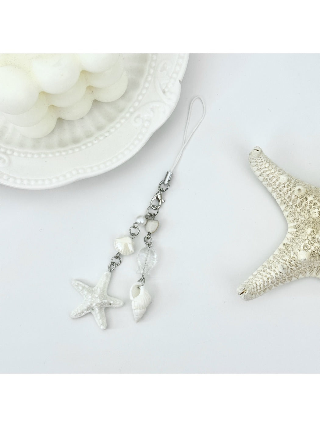 Mini starfish keychain held in a hand to show scale