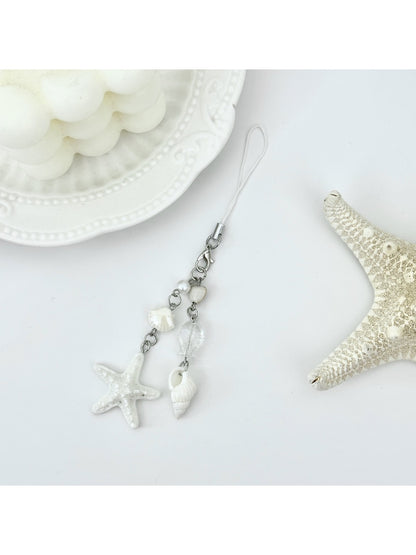 Mini starfish keychain held in a hand to show scale