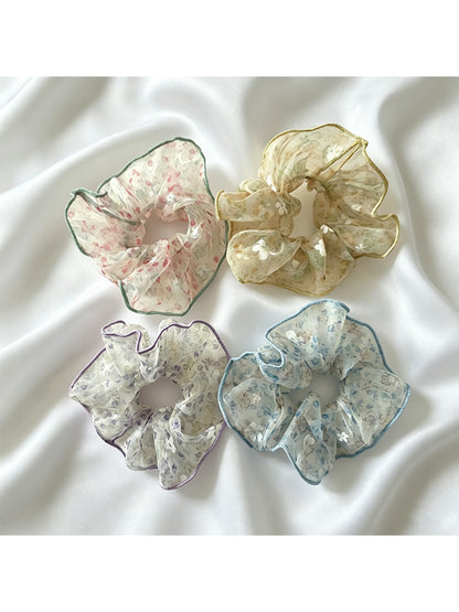 Gifty sheer tulle scrunchie with tiny pink and white floral pattern on a white background