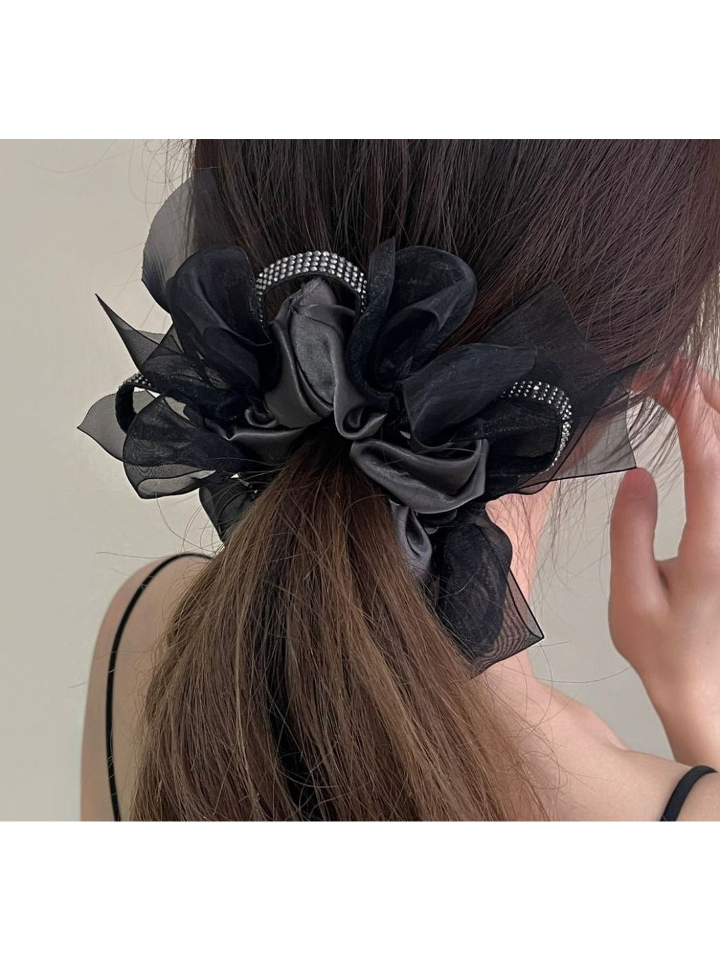 Gifty dark large bow scrunchie styled in a ponytail on a model