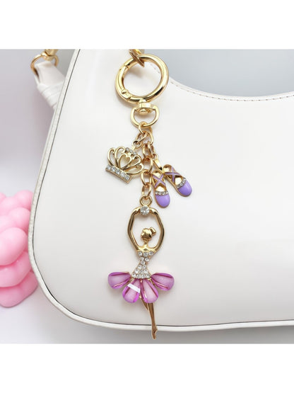 Ballerina charm keychain displayed hanging from a handbag strap