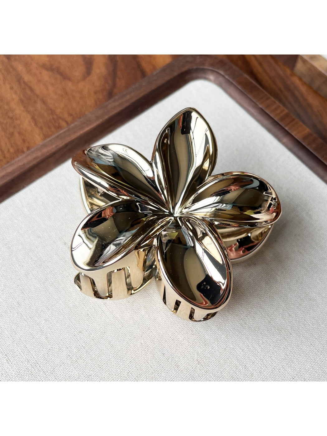 Beau flower shaped claw clip photographed with soft natural lighting