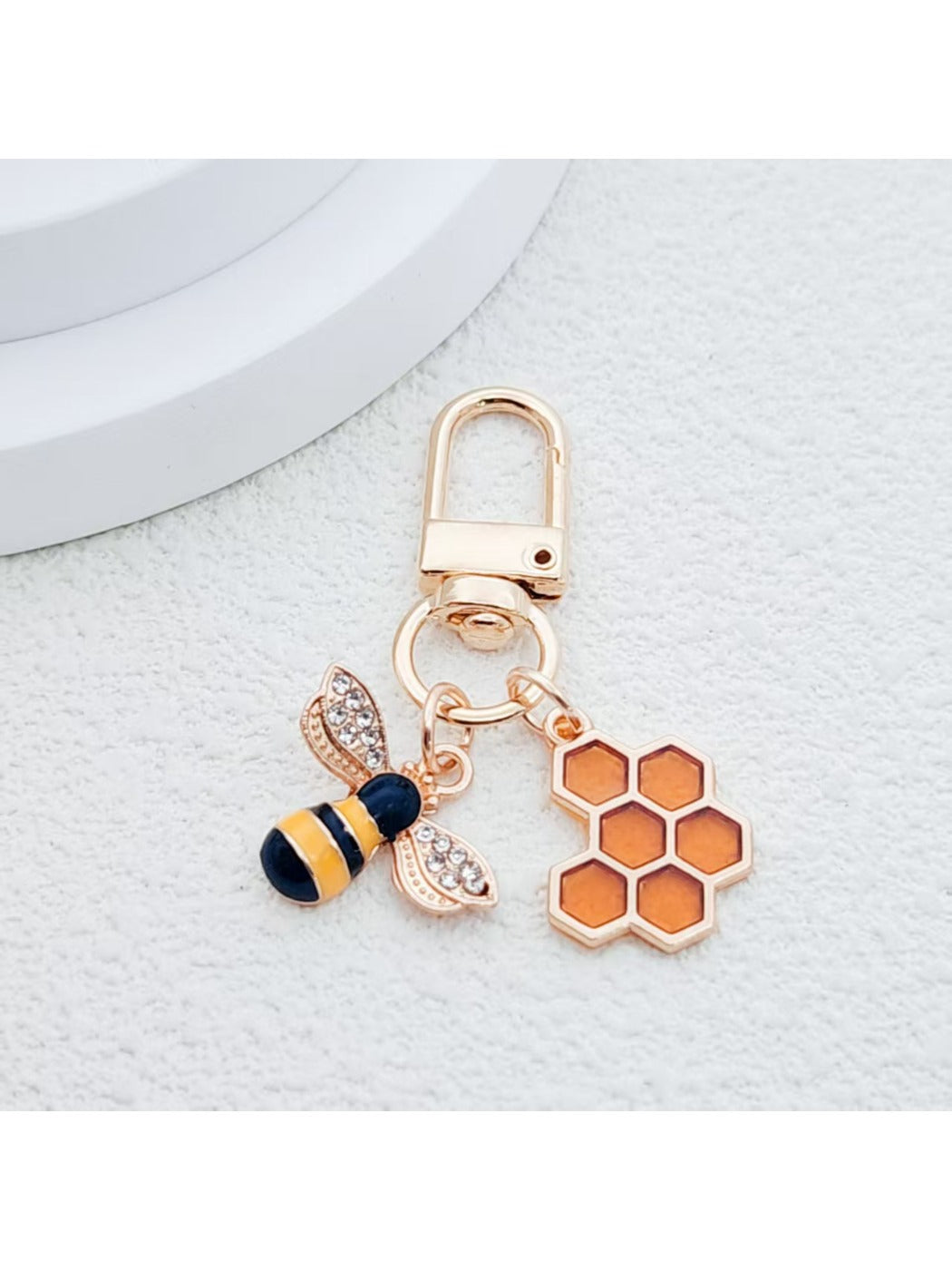Top view of bee and honeycomb keychain showing detailed design
