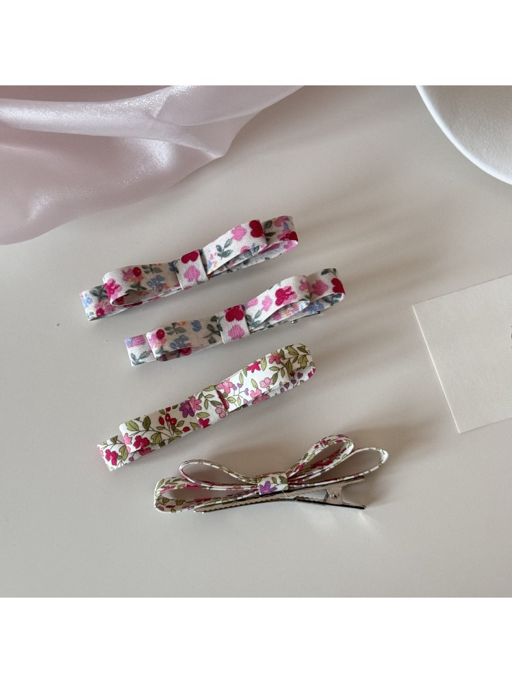 Close-up of Beau hair clip with detailed floral pattern in soft pastel colors